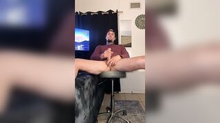 Hot tatted stud, legs spread and leaned back stroking his big ass cock
