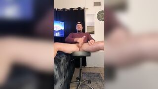 Hot tatted stud, legs spread and leaned back stroking his big ass cock