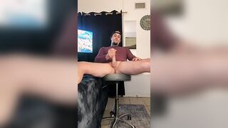 Hot tatted stud, legs spread and leaned back stroking his big ass cock
