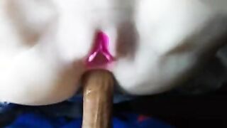 The rubber babe knows her business and silently spreads her buns!