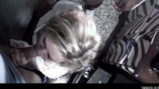 Busty MILF blowing two hard cocks in interracial swinger threesome